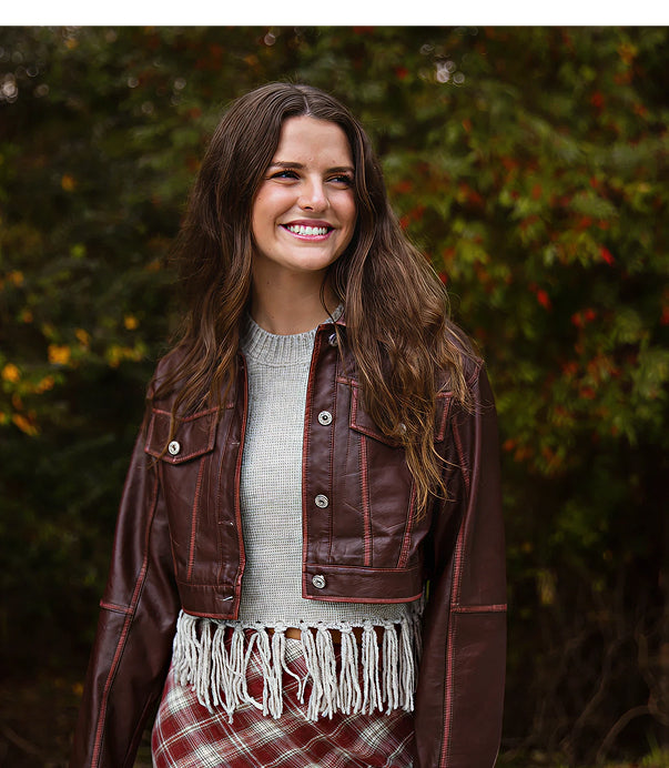 A real-life model showing affordable women’s boutique clothing in red checkers and earth tones