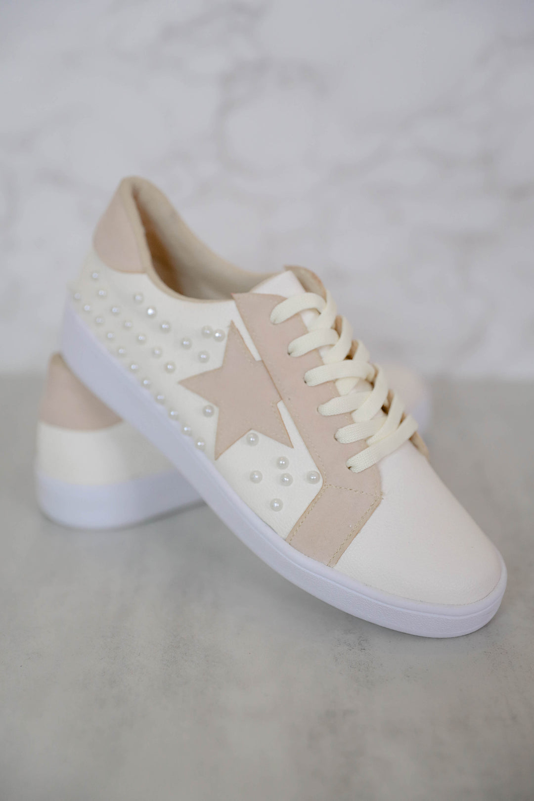 white shoes with gold stars